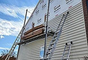Exterior siding lift installing new vinyl siding