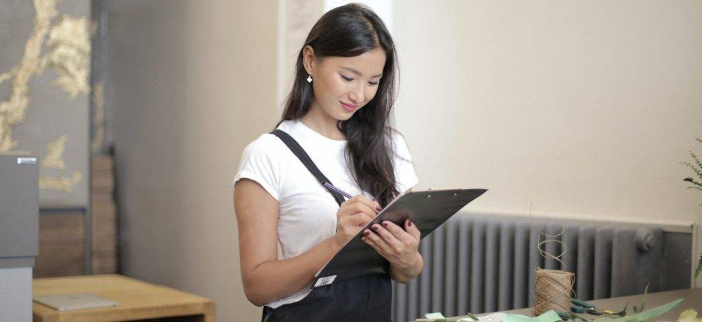 Woman holding clip board for roofing inspection review