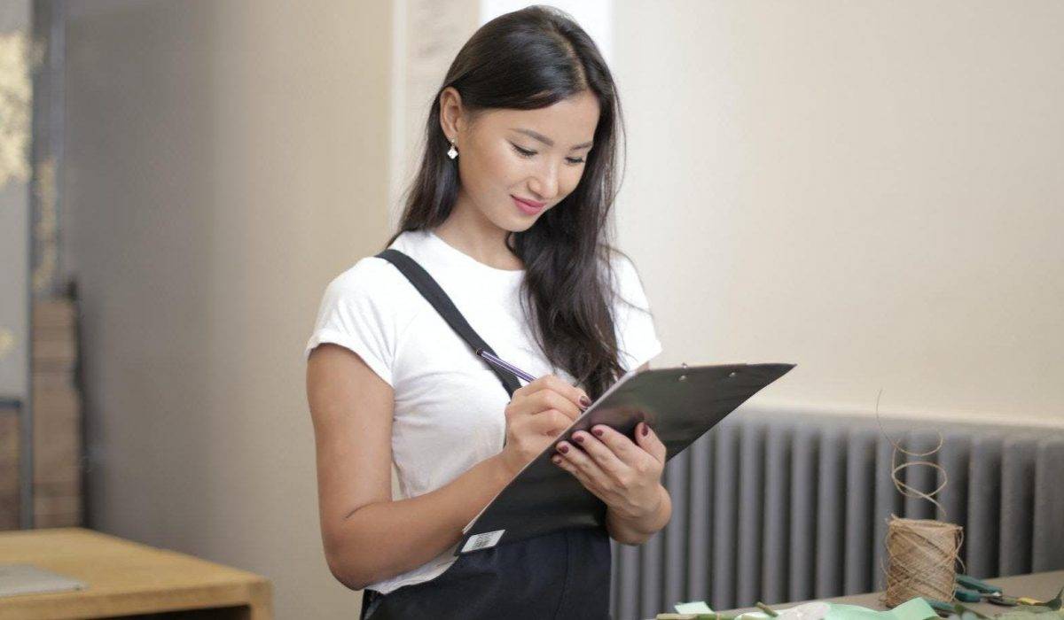 Woman holding clip board for roofing inspection review