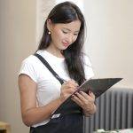 Woman holding clip board for roofing inspection review