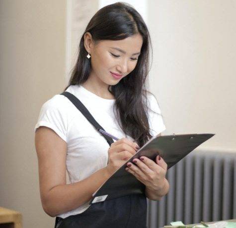 Woman holding clip board for roofing inspection review